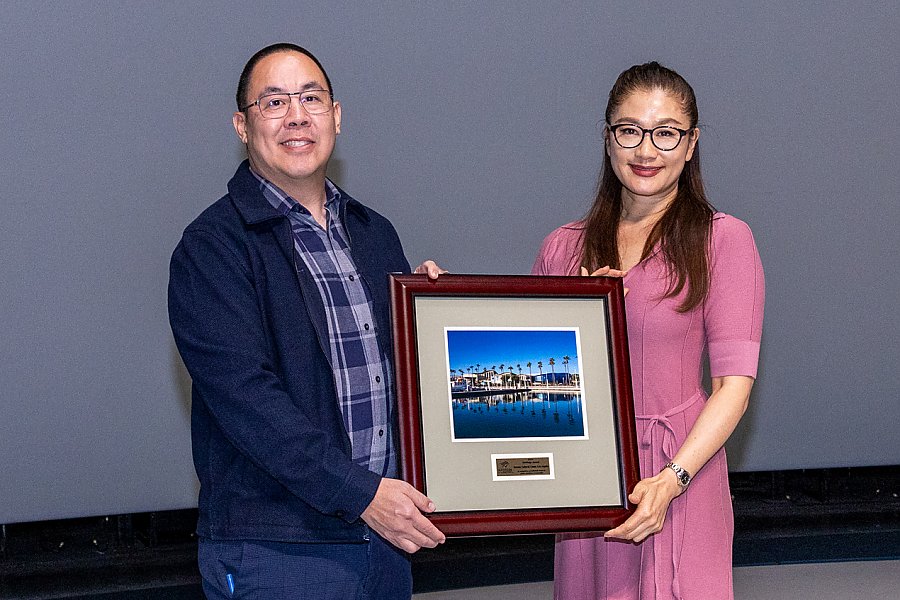 Man and woman holding a framed picture