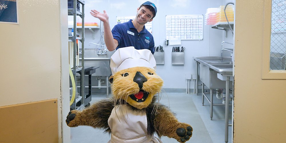 otter puppet Aquarium staff smiling